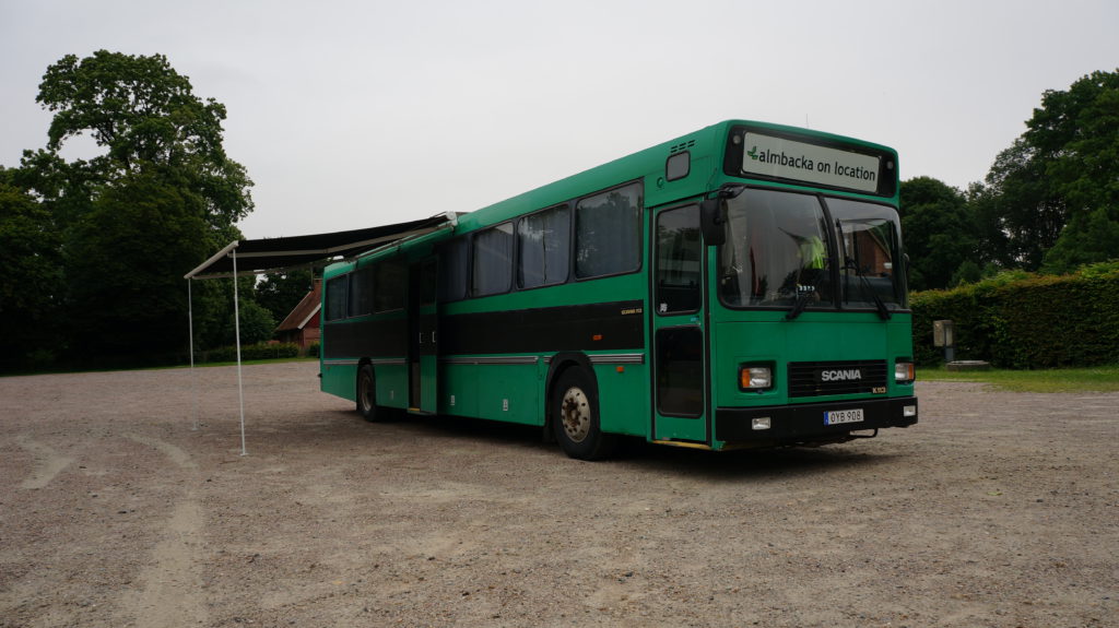 The location bus parked on gravel